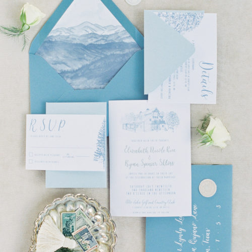Minimalistic Blue Accent Invitation for a New Mexico Destination Wedding with Venue Illustration, Watercolor, and Calligraphy on Woodgrain Paper by CallIRosa