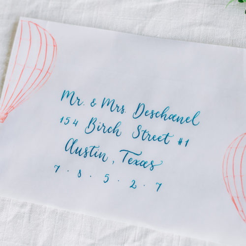 Whimsical Hot Air Balloon Inspired Vellum Envelope with Teal Calligraphy at Sunset Ranch Event Center by CalliRosa
